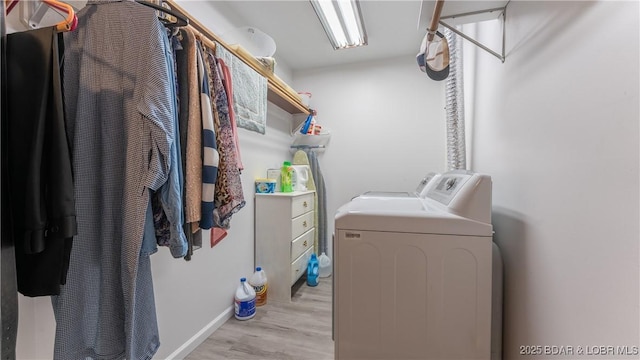 laundry room featuring laundry area, light wood-style flooring, and separate washer and dryer