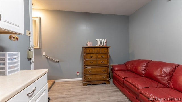 living room with baseboards and light wood finished floors