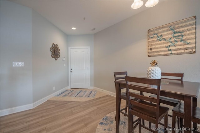 dining space with baseboards, recessed lighting, and light wood-style floors