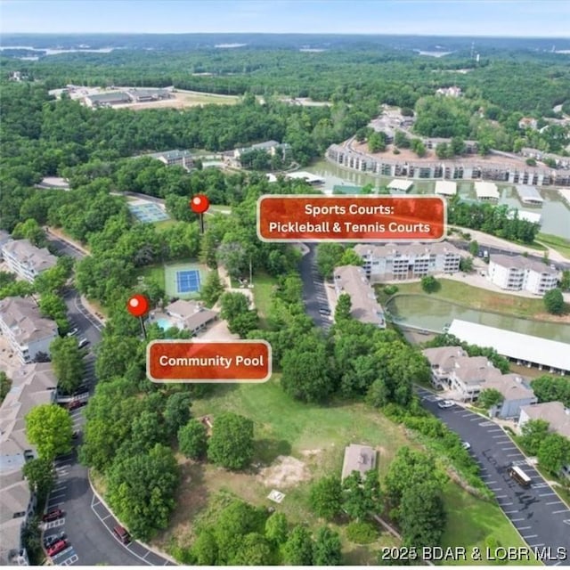 488 Regatta Bay Dr Unit 2C, Lake Ozark, MO 65049 - aerial view of property and surrounding area featuring a nearby body of water and a heavily wooded area