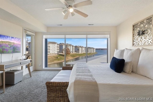 488 Regatta Bay Dr Unit 2C, Lake Ozark, MO 65049 - bedroom featuring access to outside, carpet floors, a water view, a ceiling fan, and a textured ceiling