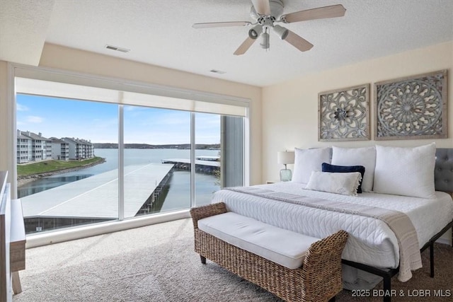 488 Regatta Bay Dr Unit 2C, Lake Ozark, MO 65049 - carpeted bedroom featuring a water view, a ceiling fan, and access to exterior