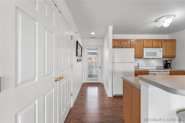 kitchen with baseboards, white appliances, dark wood-style flooring, and light countertops