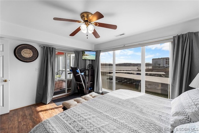 bedroom featuring access to exterior, visible vents, a ceiling fan, and wood finished floors