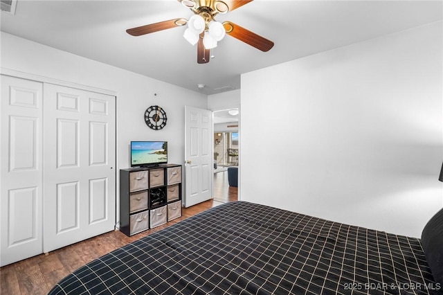 bedroom with a closet, a ceiling fan, and wood finished floors