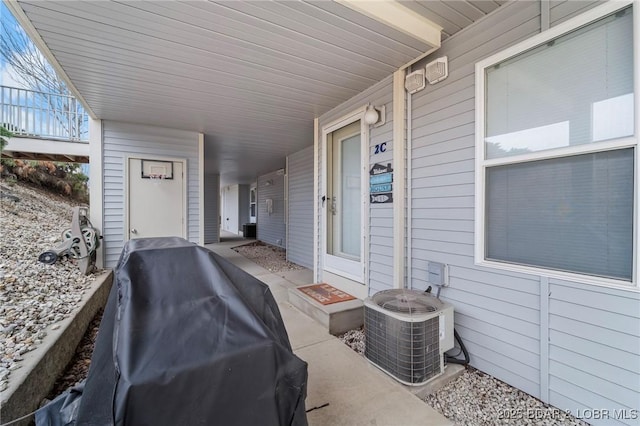 view of patio / terrace featuring cooling unit and a grill