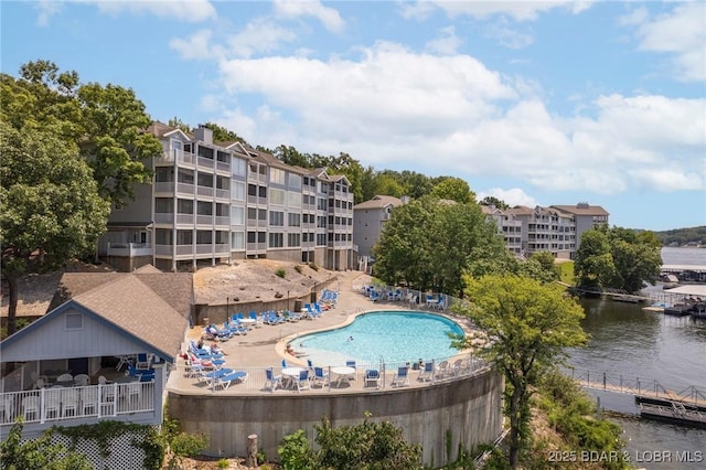 pool featuring a patio and a water view