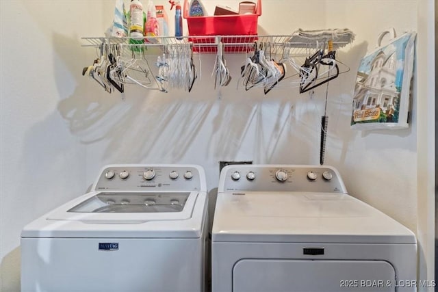 clothes washing area featuring laundry area and washing machine and clothes dryer