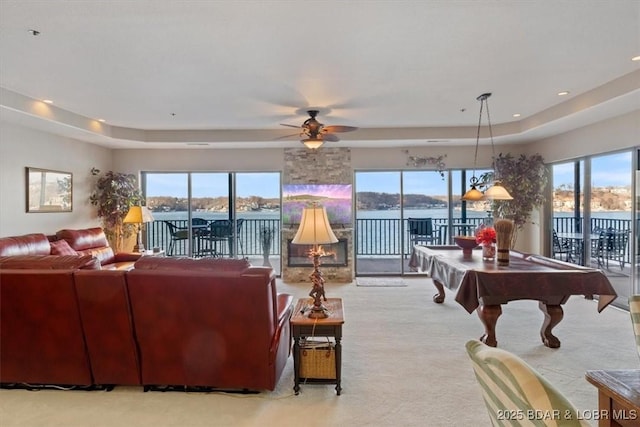 carpeted living area with billiards, a wealth of natural light, and a ceiling fan