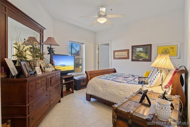 bedroom with a ceiling fan and light colored carpet