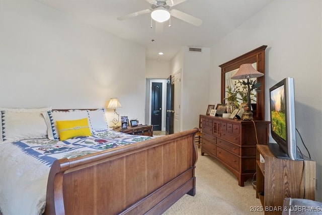 bedroom featuring light colored carpet, ceiling fan, and visible vents