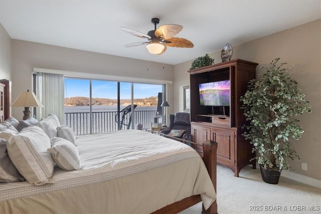 bedroom with access to exterior, light carpet, ceiling fan, and baseboards