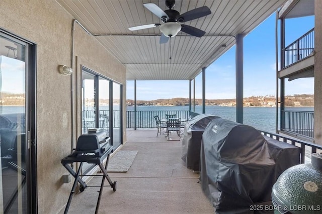 view of patio / terrace with ceiling fan, a water view, and area for grilling