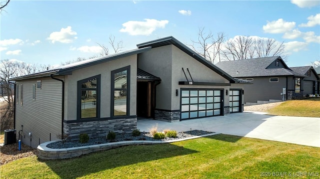 view of side of home with central air condition unit, stone siding, a yard, concrete driveway, and a garage