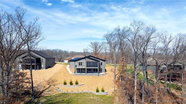 rear view of house featuring a lawn