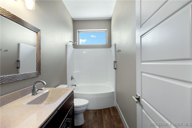 full bathroom featuring baseboards, toilet, shower / bathtub combination, wood finished floors, and vanity