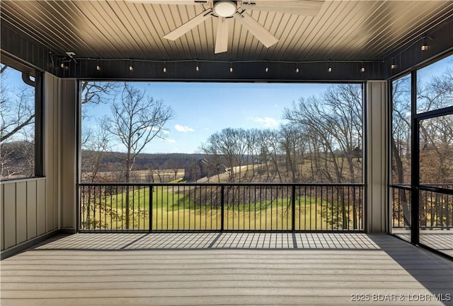 unfurnished sunroom with ceiling fan