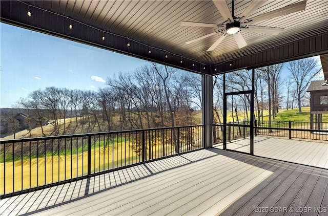 wooden deck featuring ceiling fan