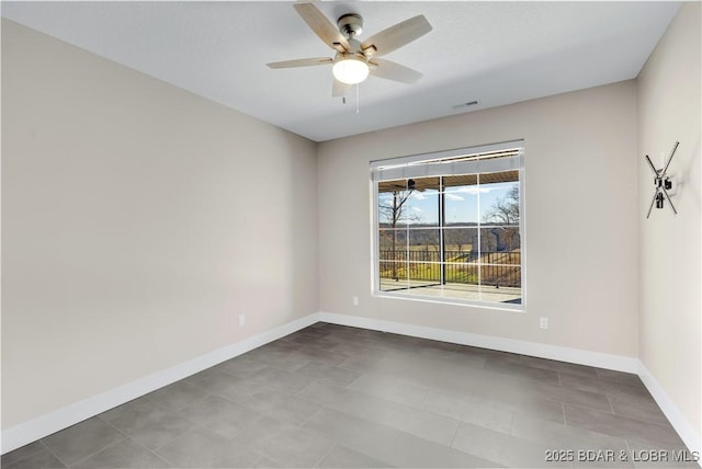 spare room featuring visible vents, baseboards, and ceiling fan