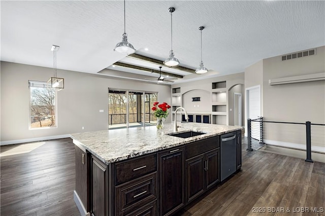 kitchen featuring visible vents, open floor plan, dark wood-style flooring, and a sink