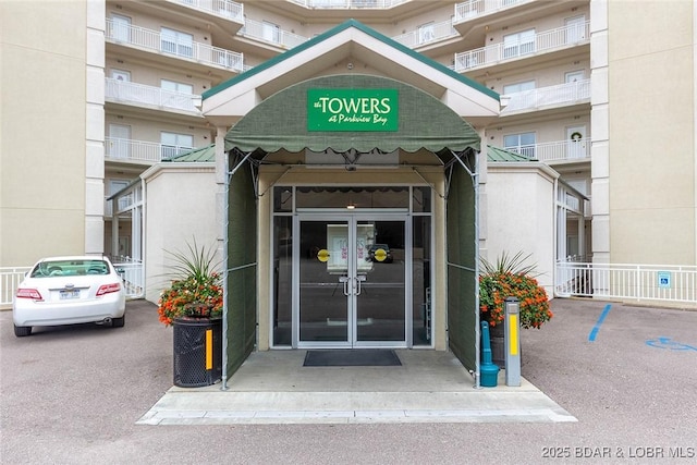 property entrance with french doors and stucco siding