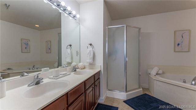 bathroom featuring a stall shower, a sink, and a bath