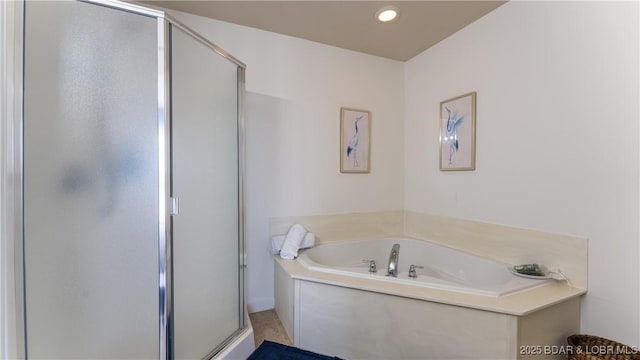 full bathroom featuring a stall shower, a bath, and recessed lighting