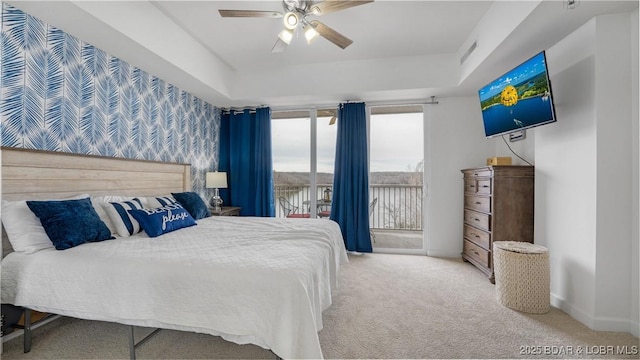 bedroom featuring carpet floors, visible vents, baseboards, access to exterior, and a raised ceiling