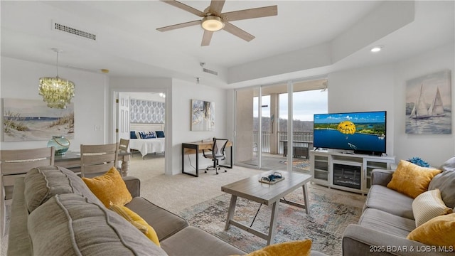 living room featuring ceiling fan, carpet, and visible vents