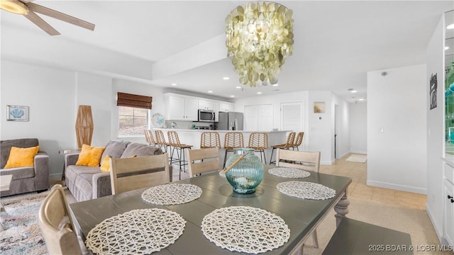 dining area featuring baseboards, light tile patterned floors, ceiling fan with notable chandelier, and recessed lighting