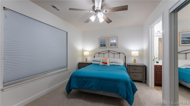 bedroom featuring visible vents, a ceiling fan, and light colored carpet