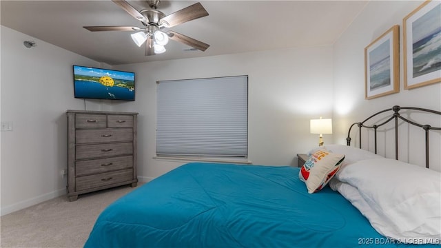 carpeted bedroom with visible vents, baseboards, and a ceiling fan