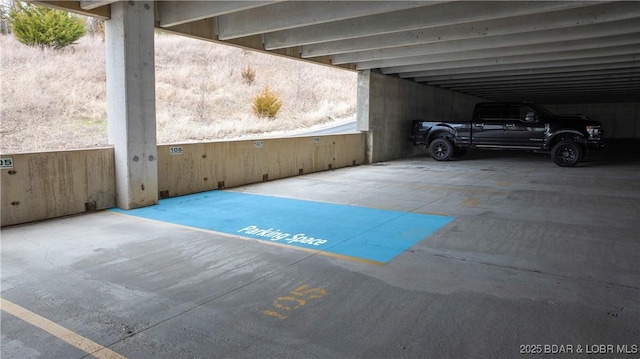 view of parking / parking lot with a parking garage