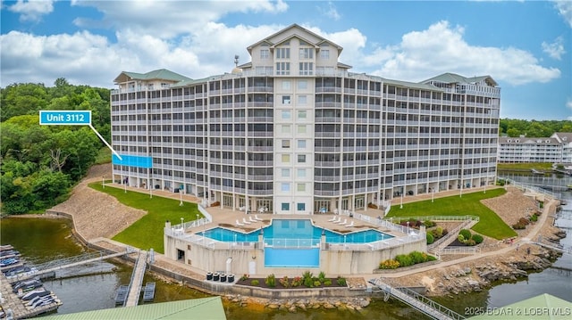 view of property with a water view and a community pool