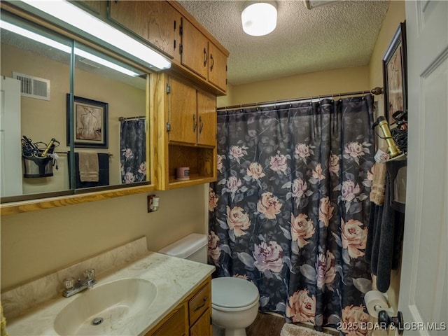 bathroom with visible vents, a shower with shower curtain, toilet, a textured ceiling, and vanity