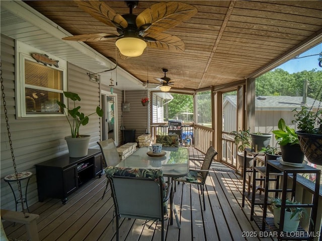 wooden terrace featuring ceiling fan and outdoor dining space