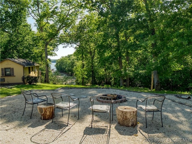 view of patio featuring an outdoor fire pit and an outdoor structure