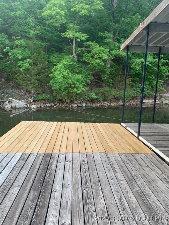 wooden deck with a forest view