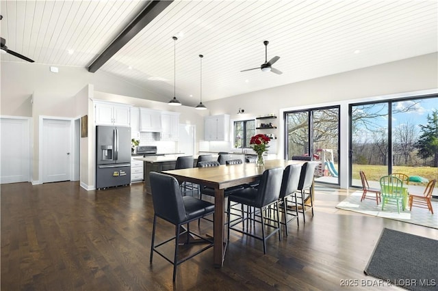 dining area with a ceiling fan, baseboards, dark wood finished floors, lofted ceiling with beams, and wood ceiling