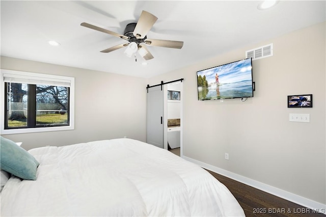 bedroom featuring visible vents, recessed lighting, a barn door, baseboards, and dark wood-style flooring