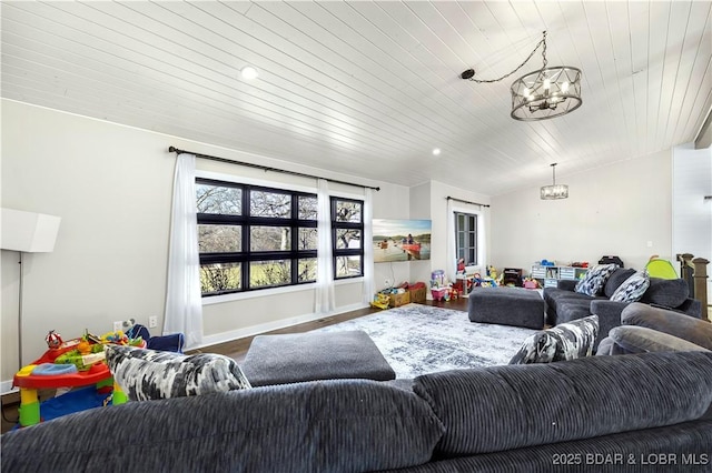 living room featuring baseboards, wood ceiling, lofted ceiling, an inviting chandelier, and wood finished floors