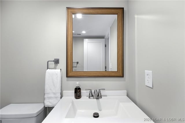 half bath with vanity and toilet