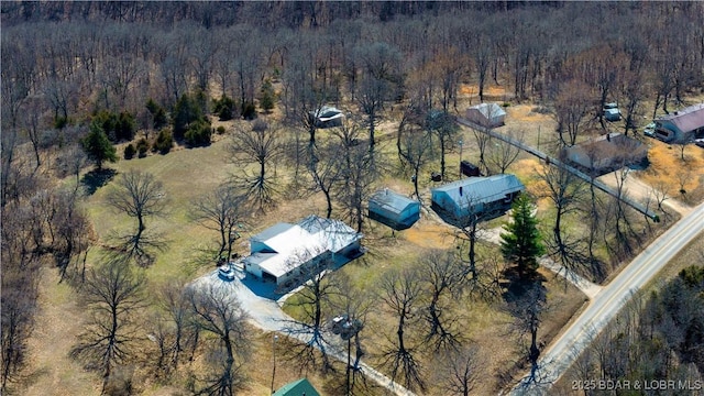 bird's eye view with a wooded view