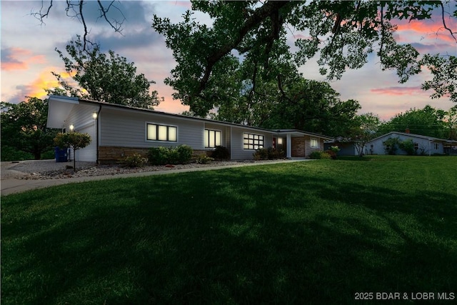 ranch-style home with a front yard and an attached garage