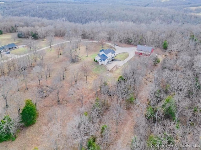 aerial view featuring a forest view and a rural view