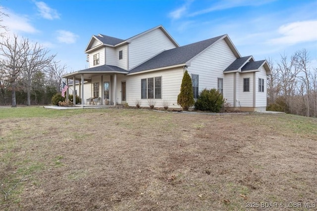 view of front of house with a front yard and covered porch