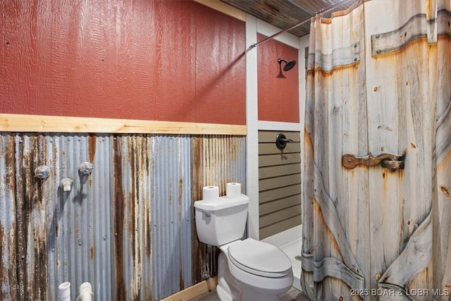 bathroom featuring a shower stall and toilet