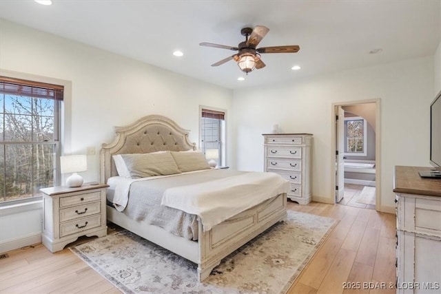 bedroom featuring light wood-style floors, baseboards, ensuite bathroom, and recessed lighting