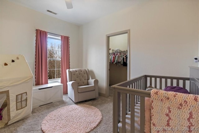 bedroom with a closet, visible vents, ceiling fan, and carpet flooring