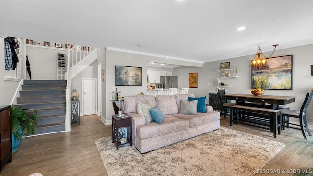 living room featuring stairway, recessed lighting, baseboards, and wood finished floors